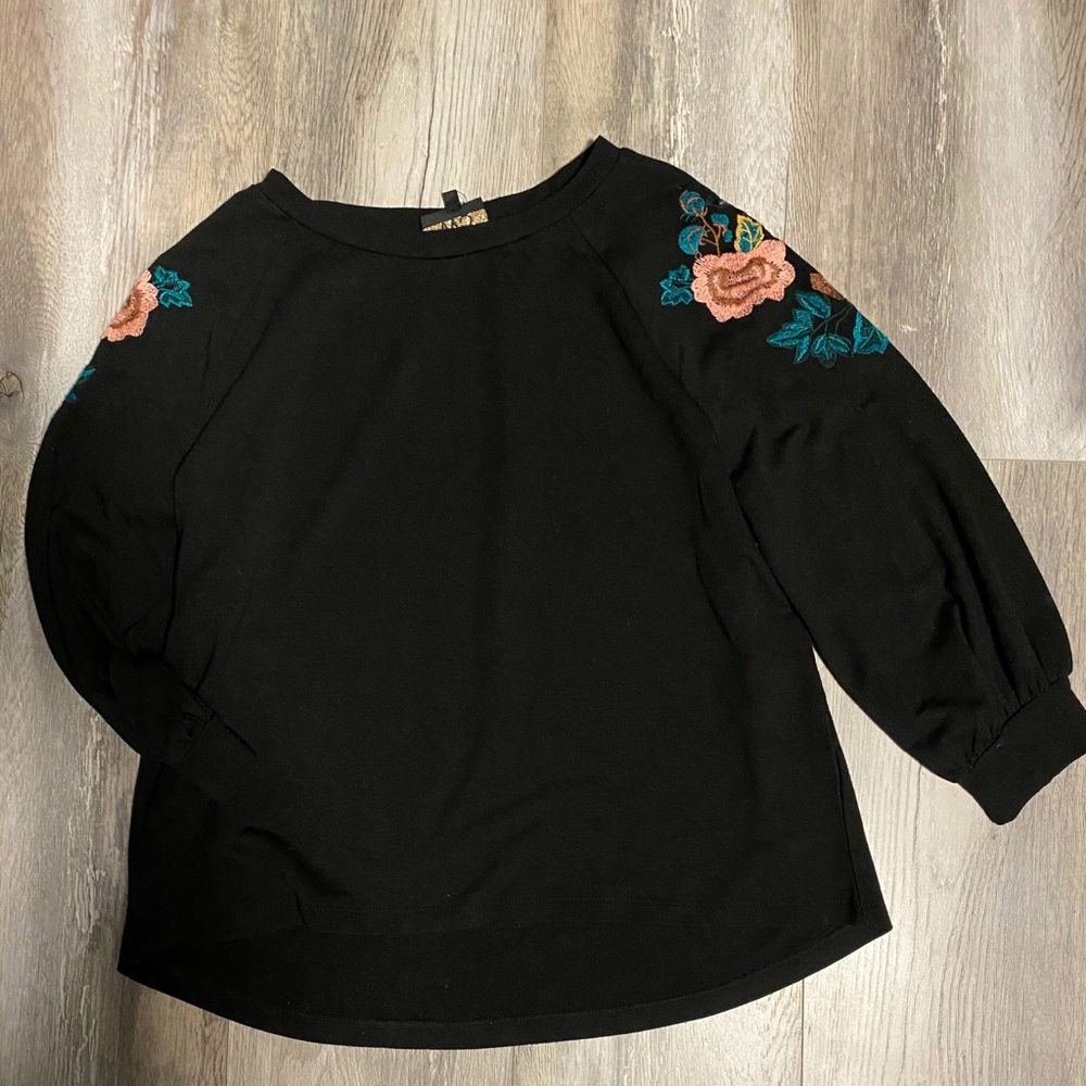 Black W5 top with floral detail on sleeves.